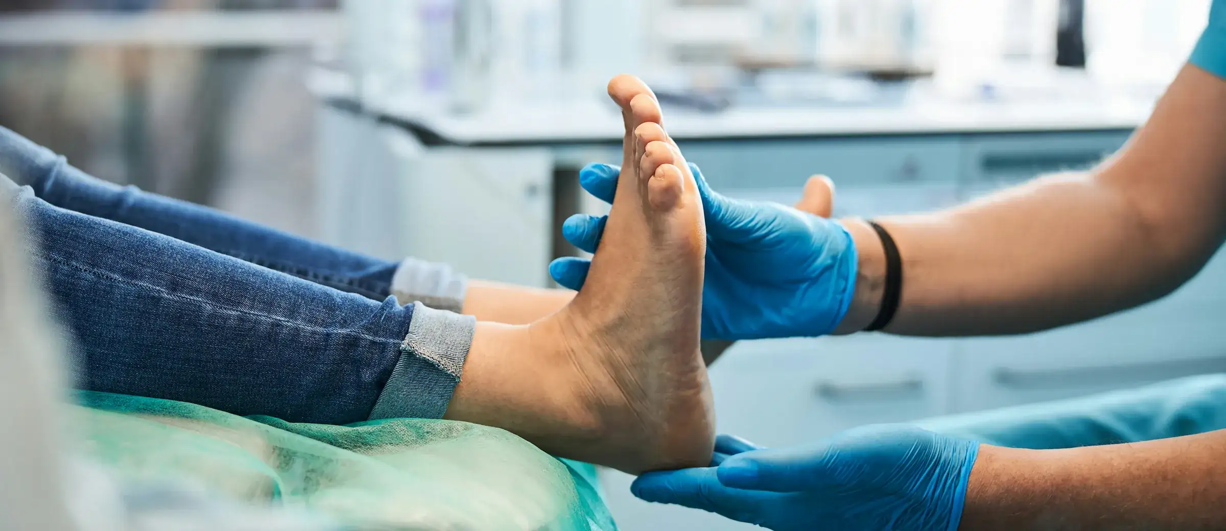 Podiatrist examining a patient’s foot in a clinic