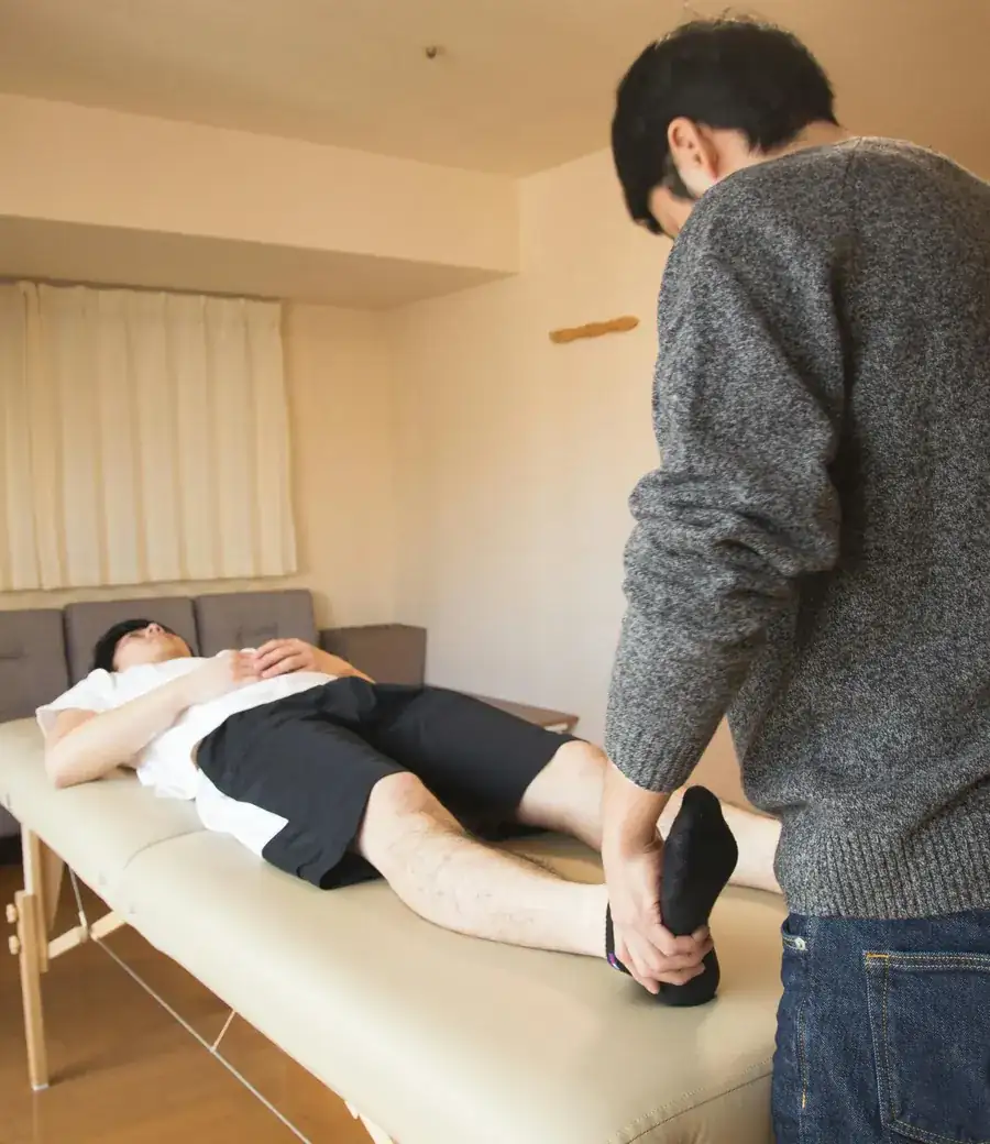Podiatrist treating a patient in clinic